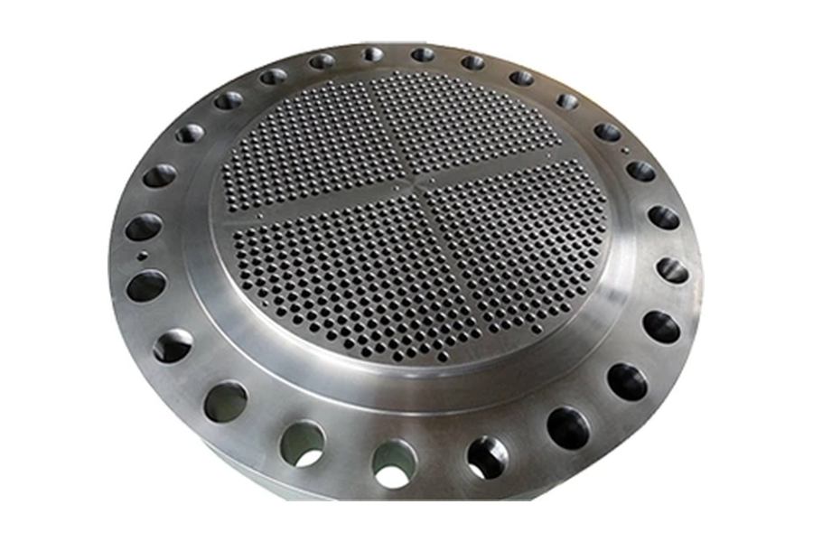 Tube sheet disc with a repeated pattern of drilled holes